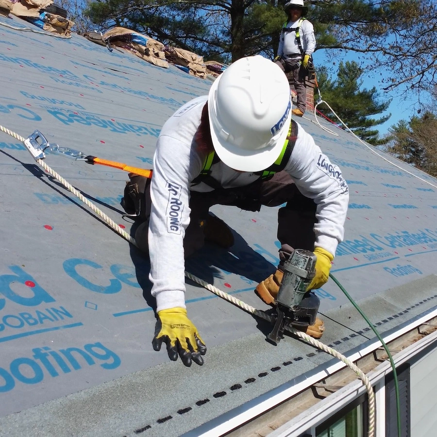long roofing team installing new roof